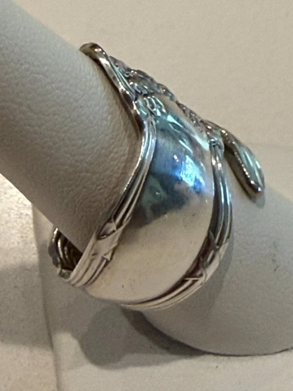 Spoon ring features an ornate floral design
